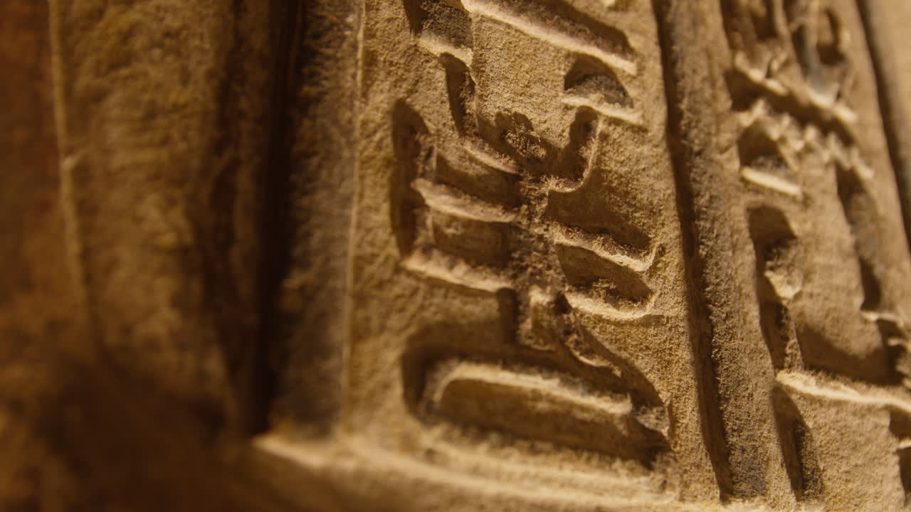 Ancient stone carving with hieroglyphs, close-up from Dendera, Egypt temple wall