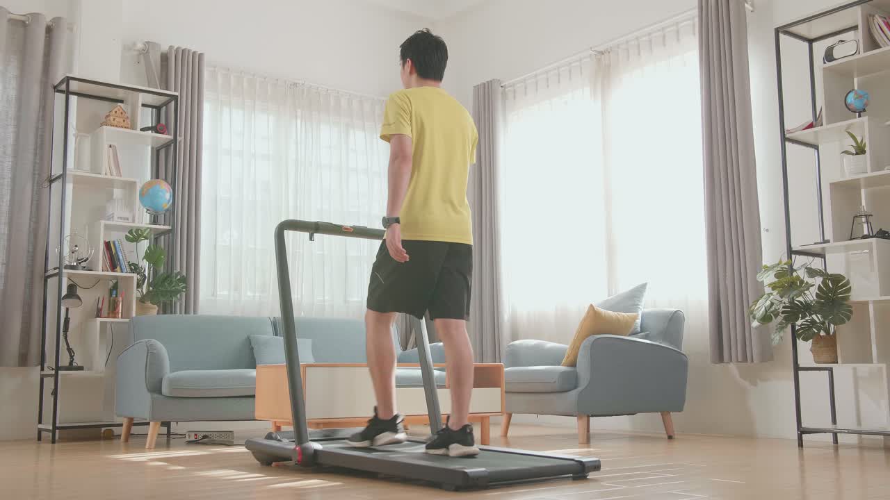 Man Walking on Treadmill at Home