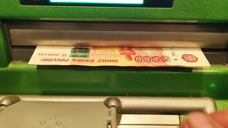 cash withdrawal in ruble banknotes at an atm.