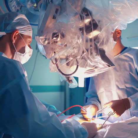 operation through the microscope. medical specialists perform surgery using modern equipment inside the operating room. neurosurgical department.