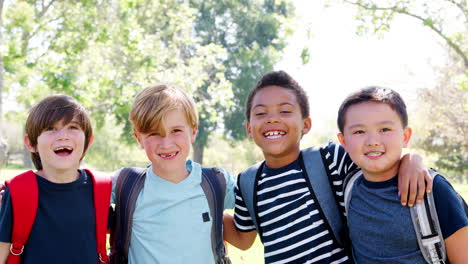 portrait of group of young boys with friends in park shot in slow motion