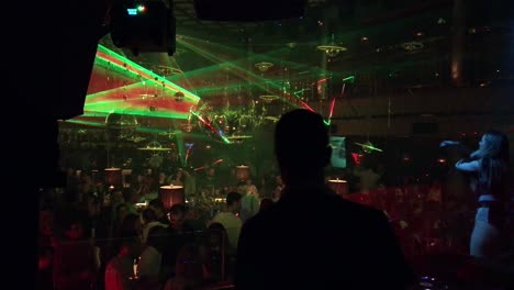 vibrant nightclub scene with laser lights and dj