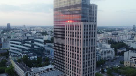 sunset reflections on a skyscraper in a city