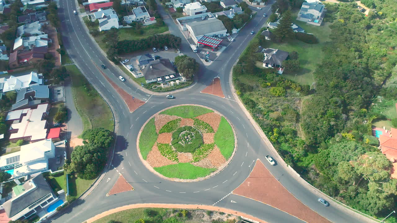 Arcing aerial view of traffic flowing around roundabout in Hermanus