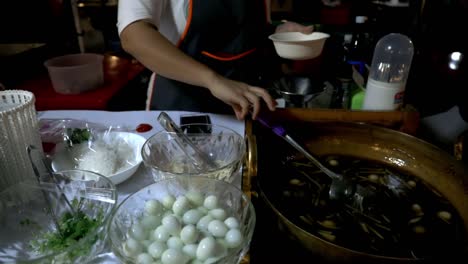 woman preparing the soup at the night market in bangkok