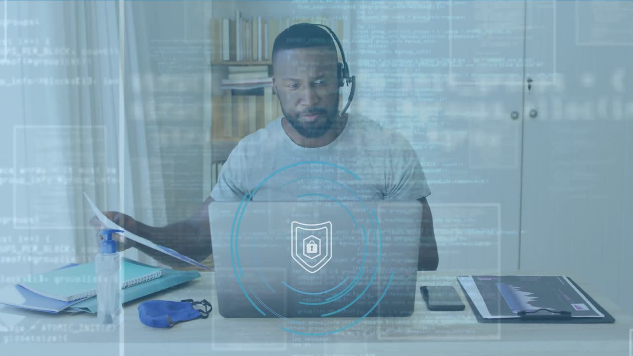 Animation of padlock and data processing over biracial businessman using laptop