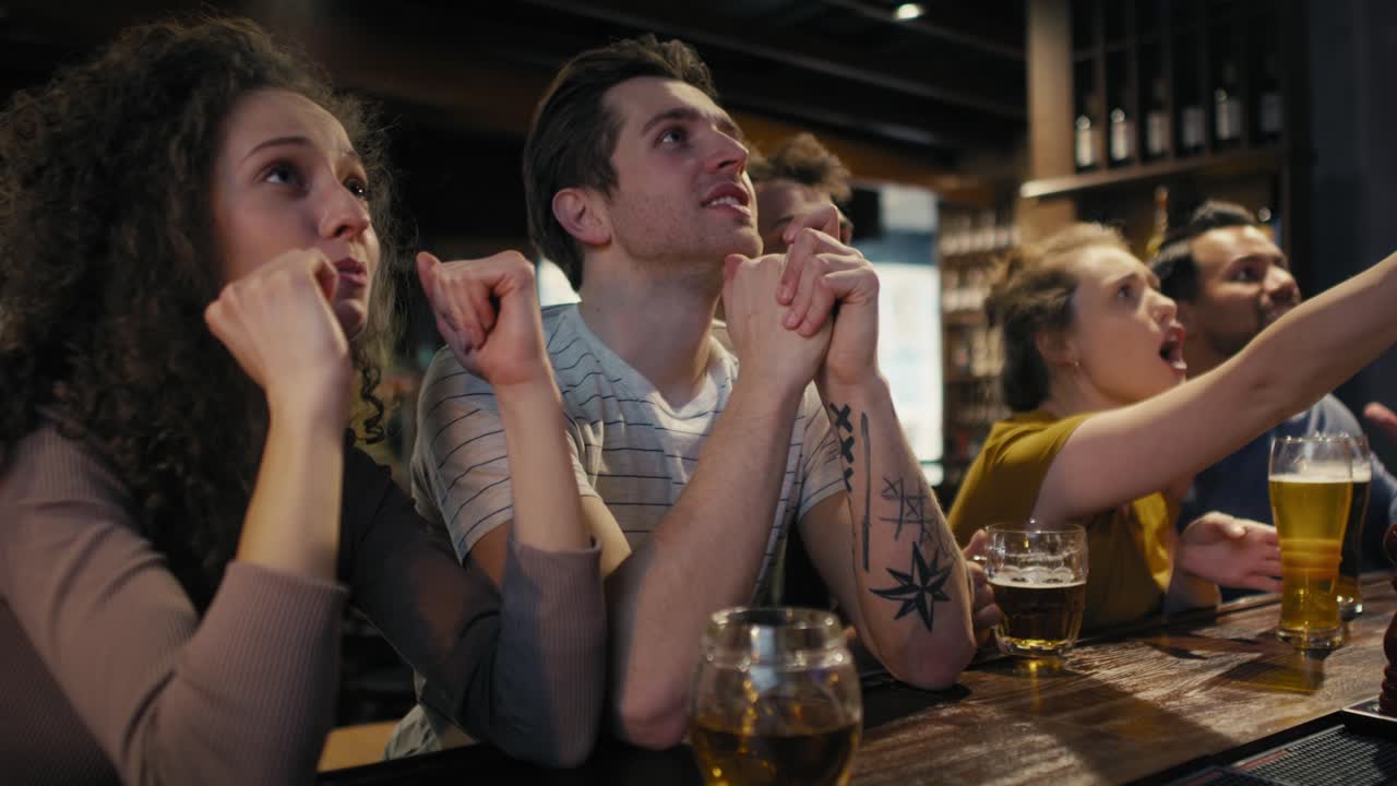 Amici che applaudono i tifosi di calcio nel pub