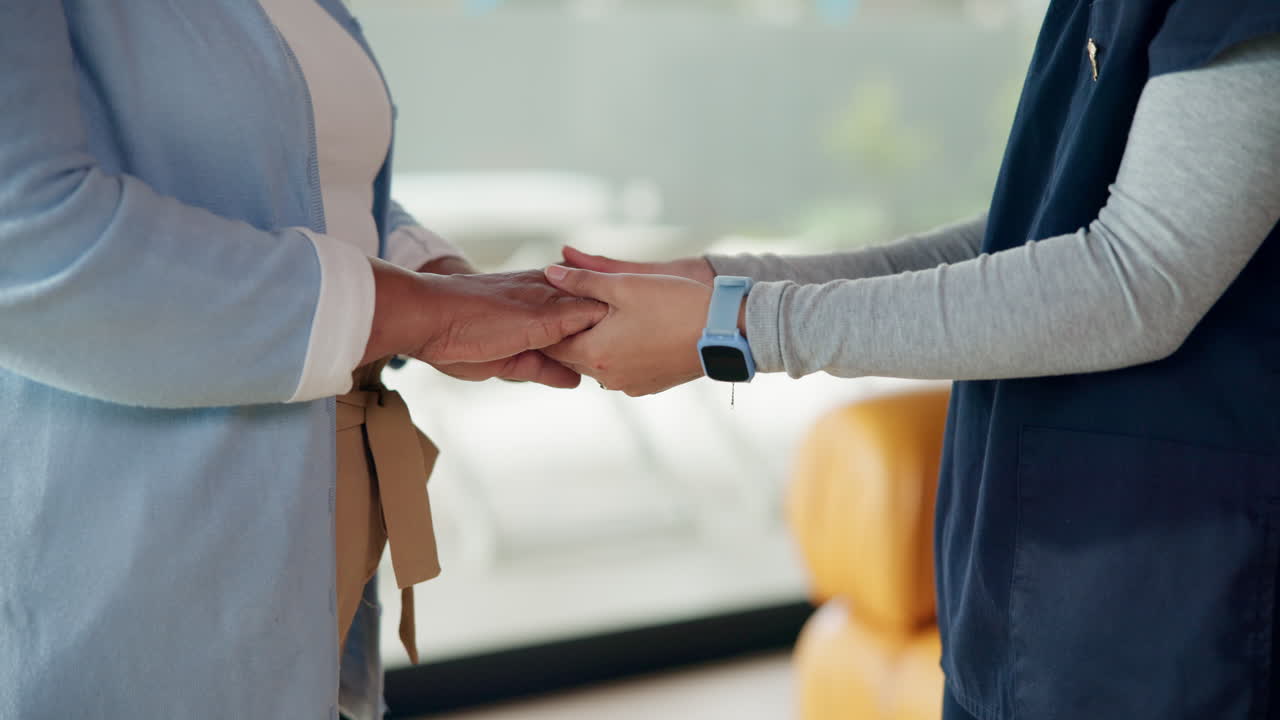 Healthcare Professional Gently Holding Patient's Hands for Comfort