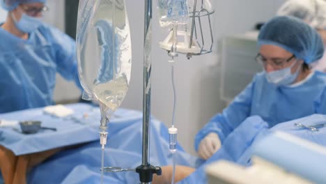professional surgeons during surgery. sick old woman. surgery.
