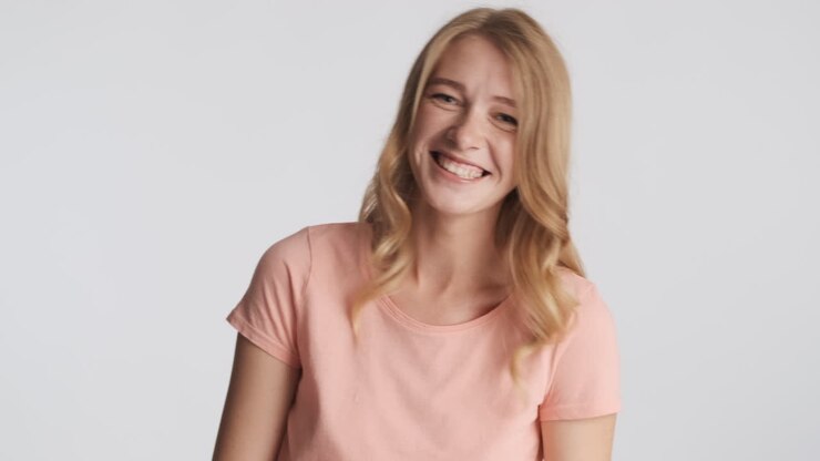 Caucasian woman laughing on camera.