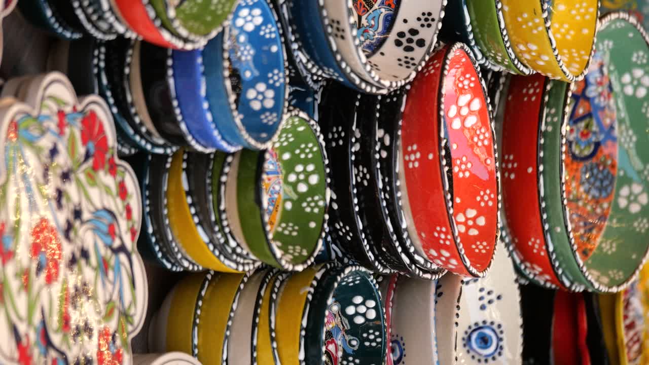 Colorful Hand-Painted Ceramic Bowls and Plates on Display