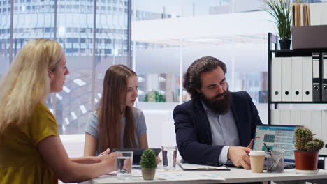 financial advisor looking at market shares growth with customers in office