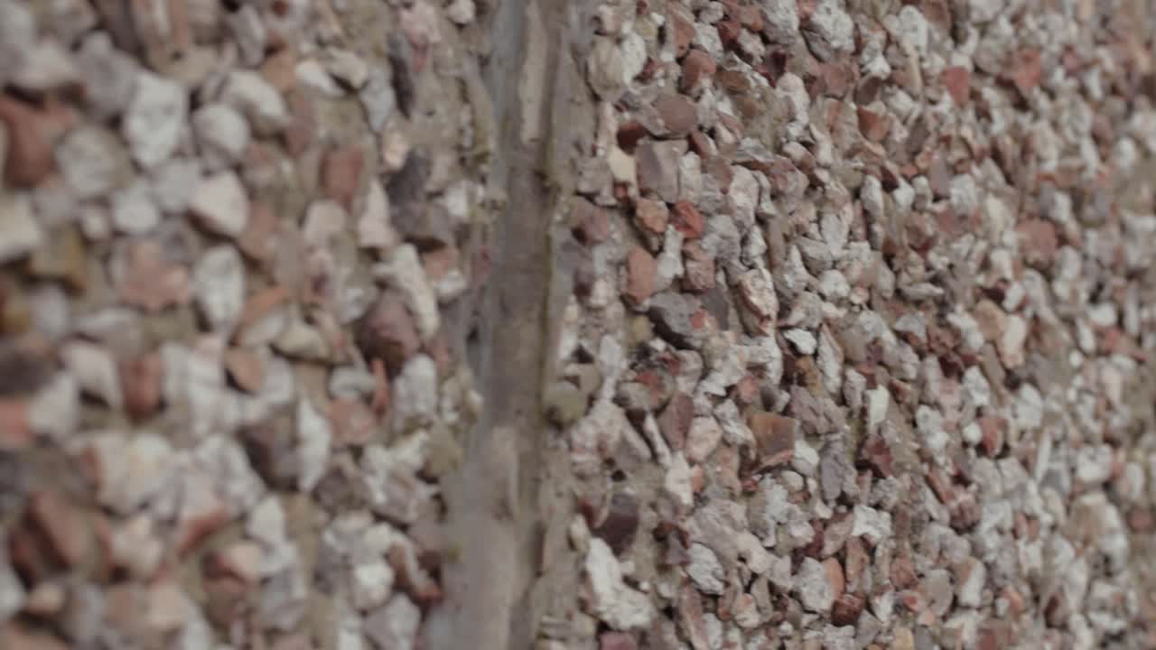 Pebble dash surface mixture of concrete and pebbles applied on building