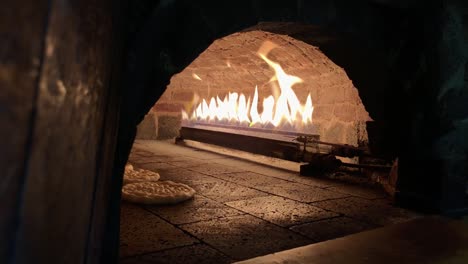 bread inside the oven,removing bread from brick oven,pitta bread,turkish pizza pita inside the oven