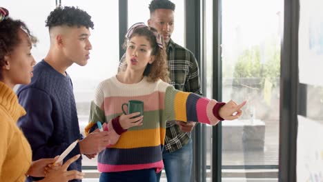 Happy-diverse-business-people-discussing-work-with-glass-wall-at-meeting-in-office-in-slow-motion