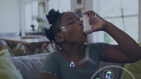 animation of eco icons and data processing over african american girl using inhaler at home