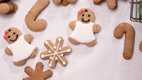 decorating gingerbread cookies with royal icing for christmas.