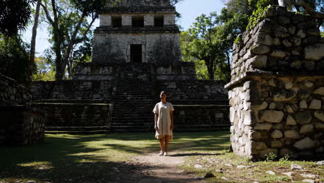 woman in front of ancient mayan ruins