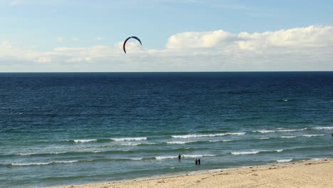 Surfers-Enjoying-Sea-Activities-On-Tropical-Hayle-Beach-In-Cornwall,-England