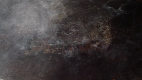 smoke rising from a hot cooking surface