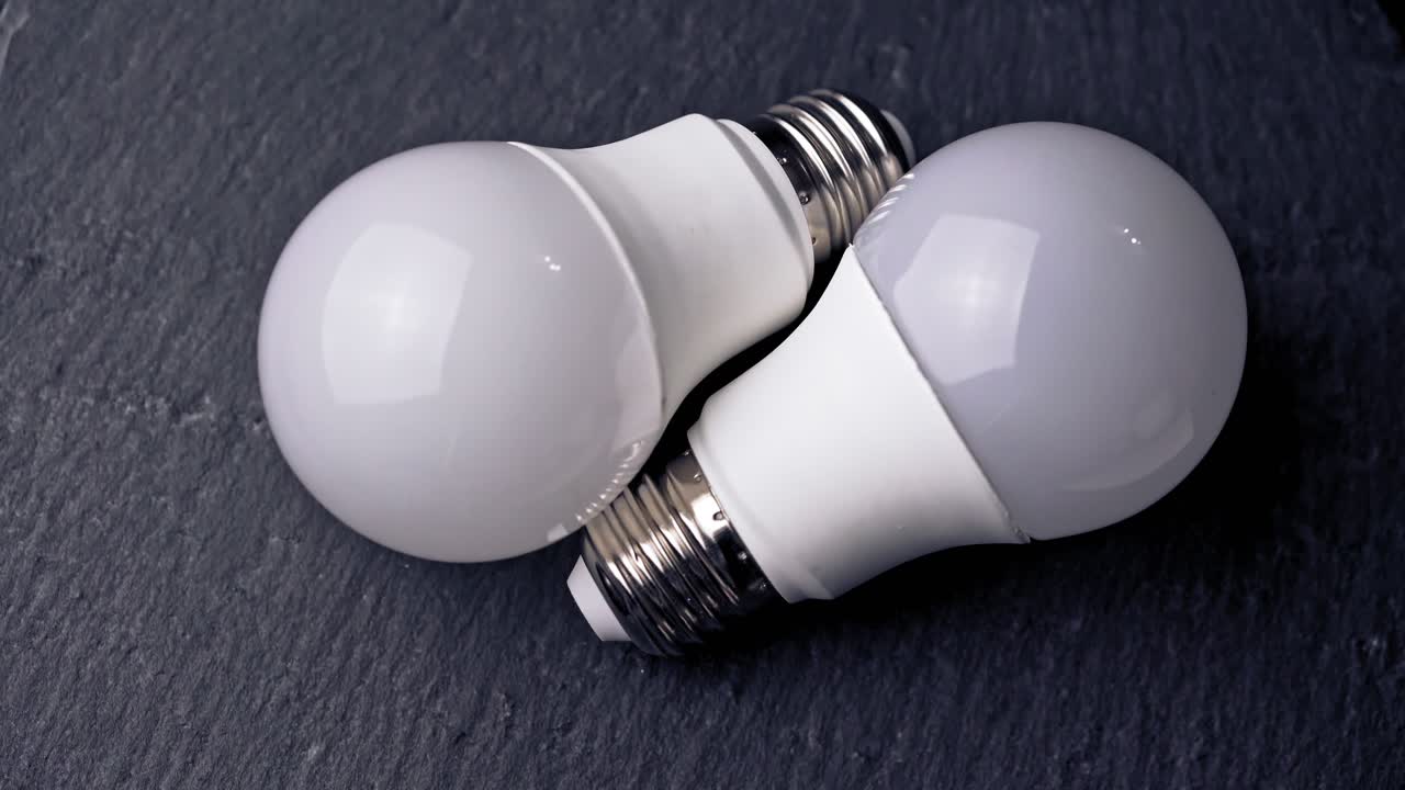 Energy saving light bulb on a black background.
