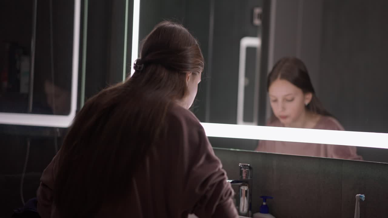 Woman washing in bathroom