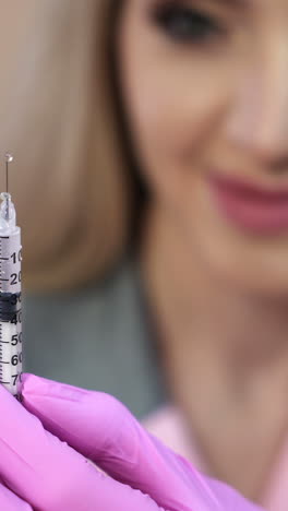 Doctor in a dressing gown and gloves, preparing an injection syringe. Vertical video