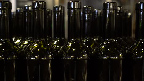 empty bottles moving along on a conveyor belt to be filled and labeled for sale and distribution - isolated