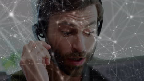 animation of network of connections over businessman wearing phone headset