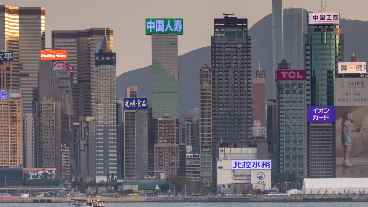HONG KONG - 19 MARCH 2025 : Hong Kong Central city skyline filmed from across the harbour in kowloon