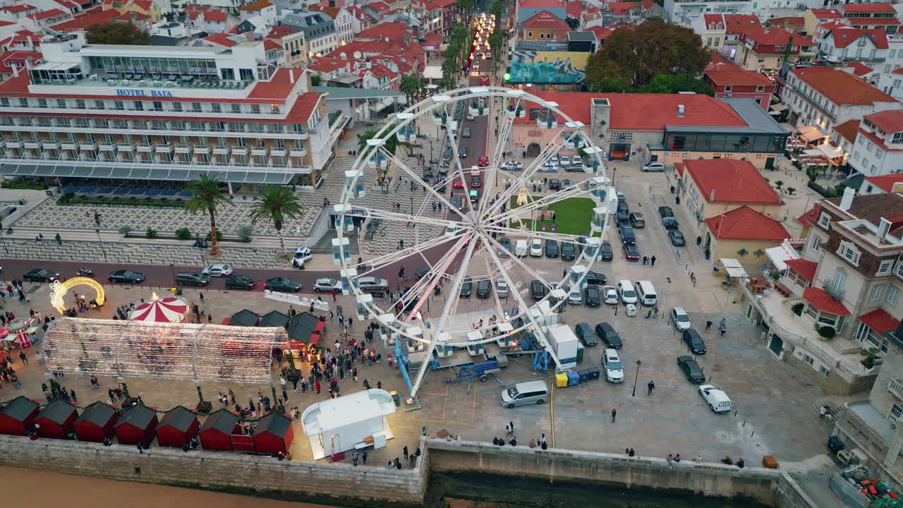 Modern ferris wheel evening carnival in  town square. City attractions