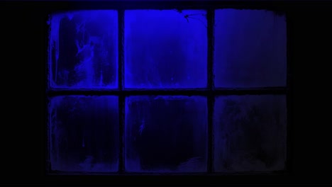police car lights flashing red and blue outside dirty window at night. crime scene or emergency concept for film