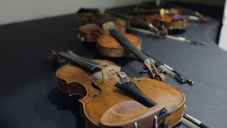 footage of several violins on a piano before the concert,