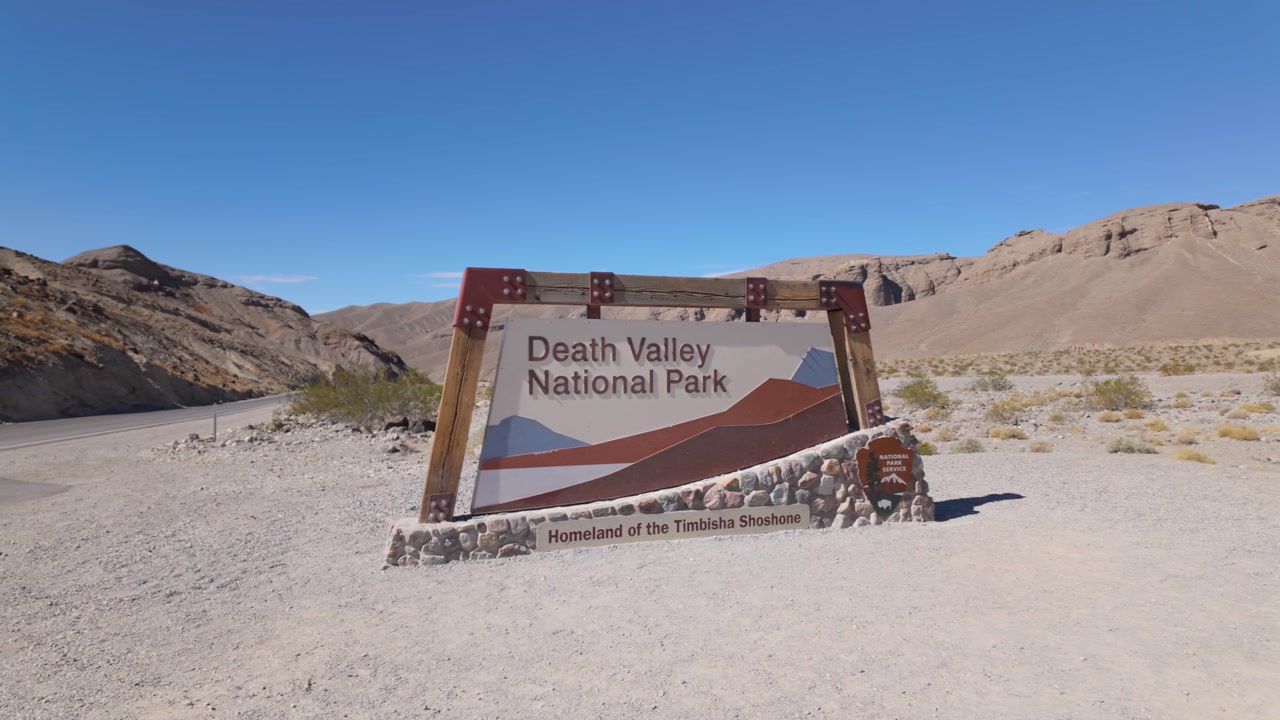 Gimbal close-up panning shot of the Death Valley National Park entrance signage in Southern California. 4K