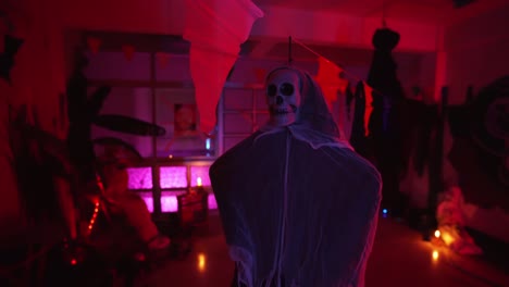room decorated for halloween party with a skeleton hanging on a rope in the center