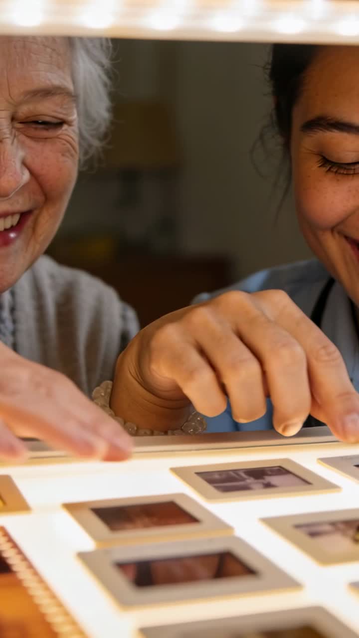 Happy Senior Woman and Young Woman Looking at Photo Slides