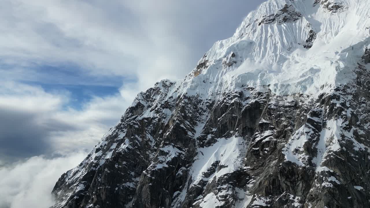 Majestic Salkantay peaks illuminated by glorious sunset, clouds rolling over dramatic Andean ridges