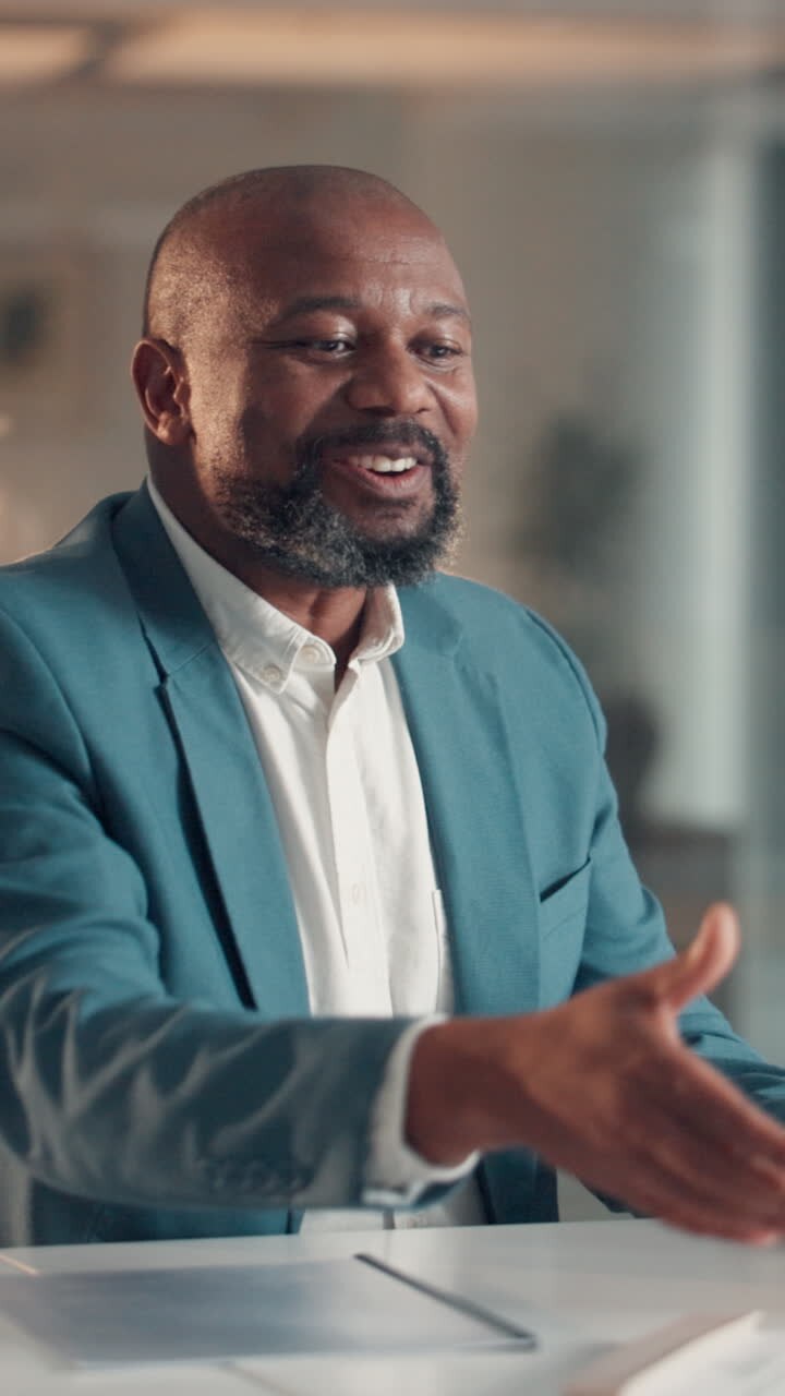 Happy Businessman Shaking Hands and Talking in an Office Meeting