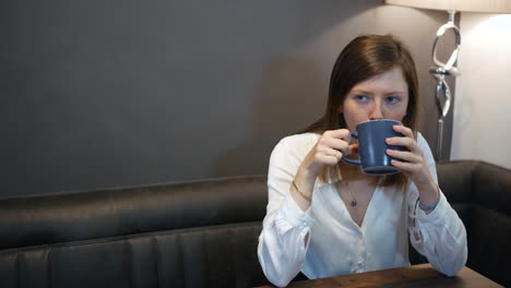 young professional female drinking coffee at home