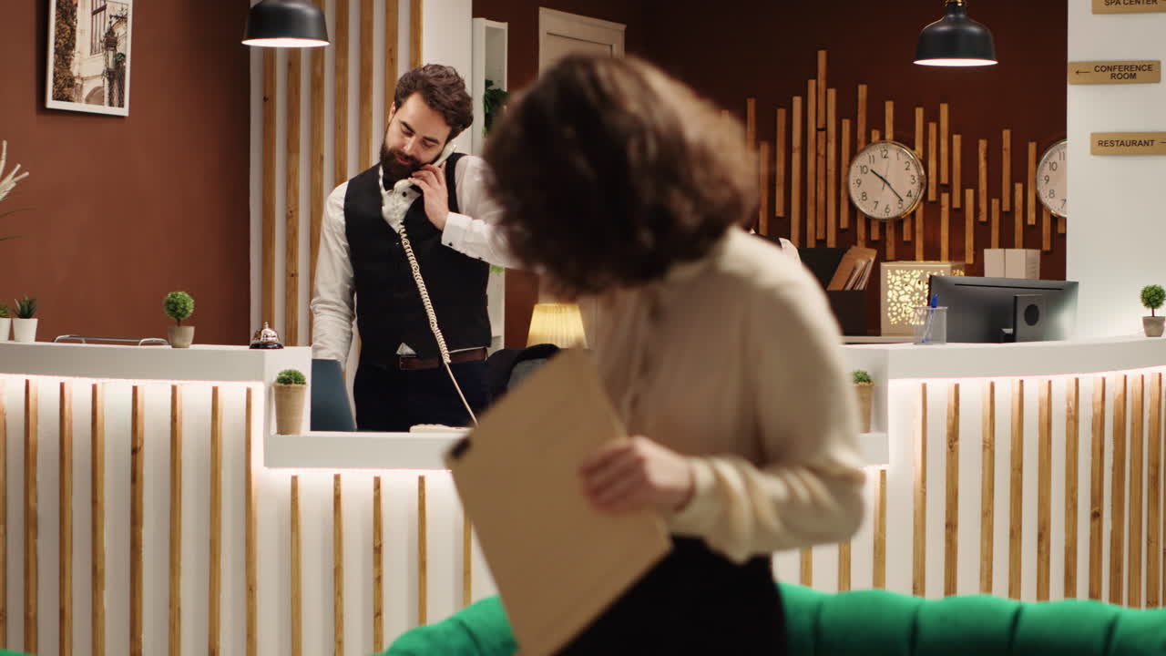 Happy receptionist assisting tourists