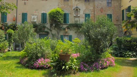 typical green courtyard garden landscape on a sunny day in northern italy