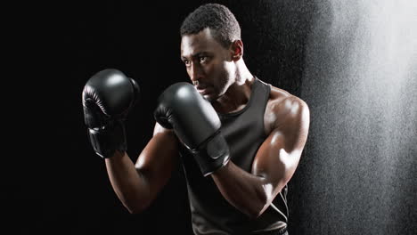 african american boxer ready in the ring on a black background