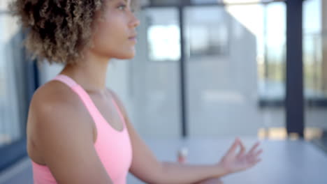 meditating, woman practicing mindfulness and relaxation at home in bright room, copy space