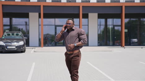 African businesman using smartphone. Handsome african american young man using phone outdoor