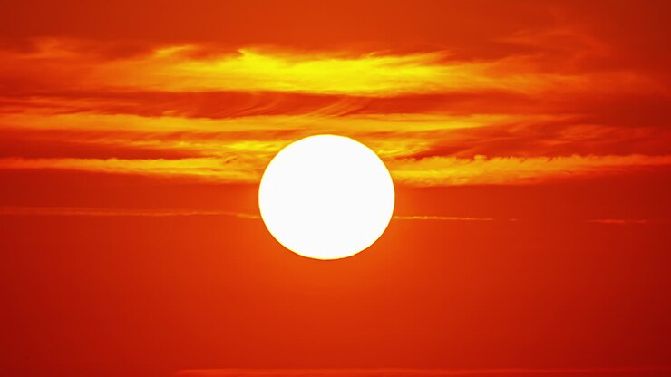 The golden sun like a ball of fire as it goes across the sky at sunset - time lapse