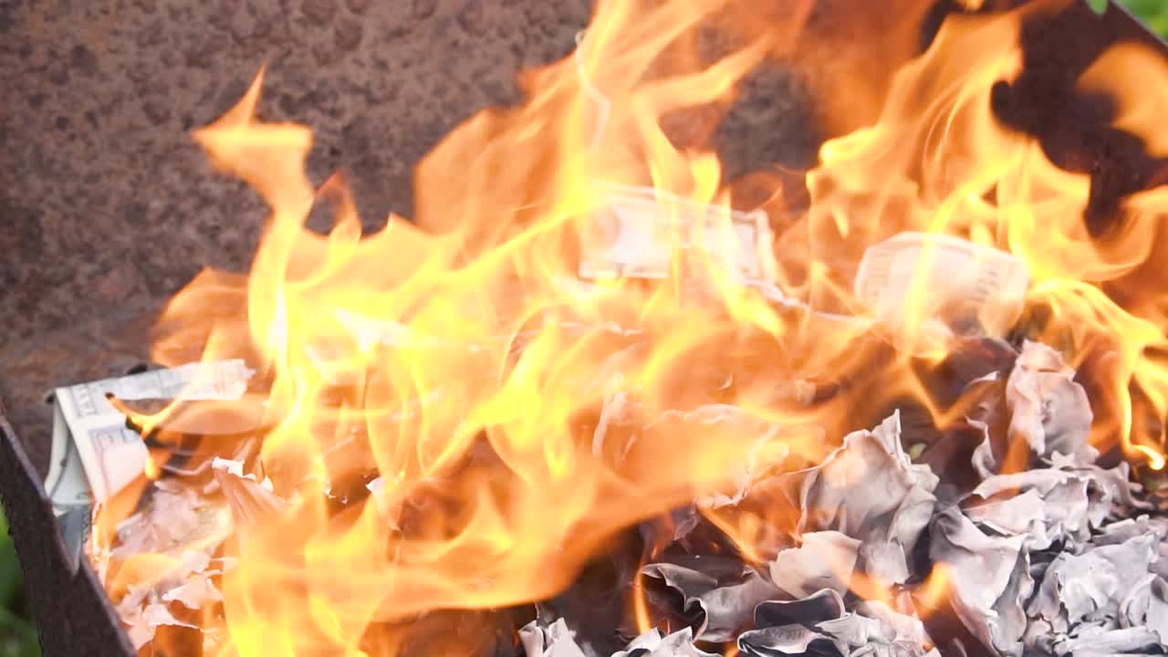 Dollar bills burn in flames. Burning currency. Concept of crisis, loss, recession or failure. Counterfeit money