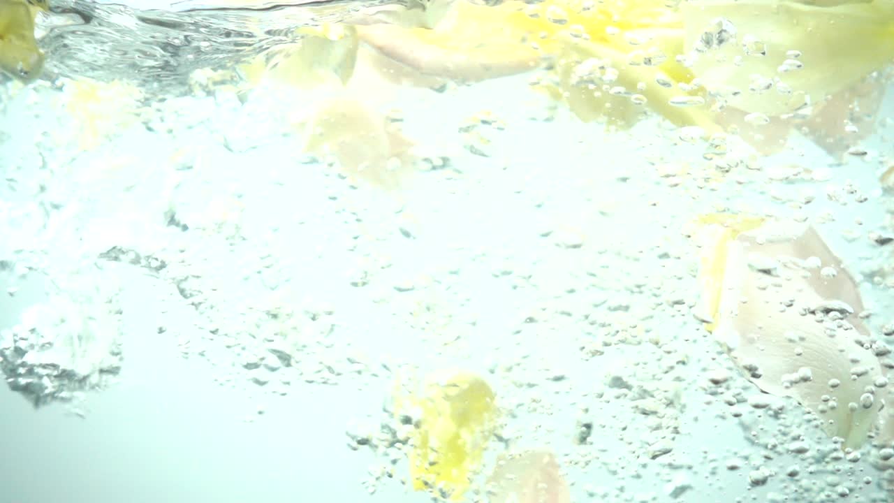 Petali di rose cadono nell'acqua. Sfondo. Movimento rallentato.