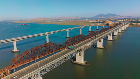 aerial view of a long bridge spanning a river