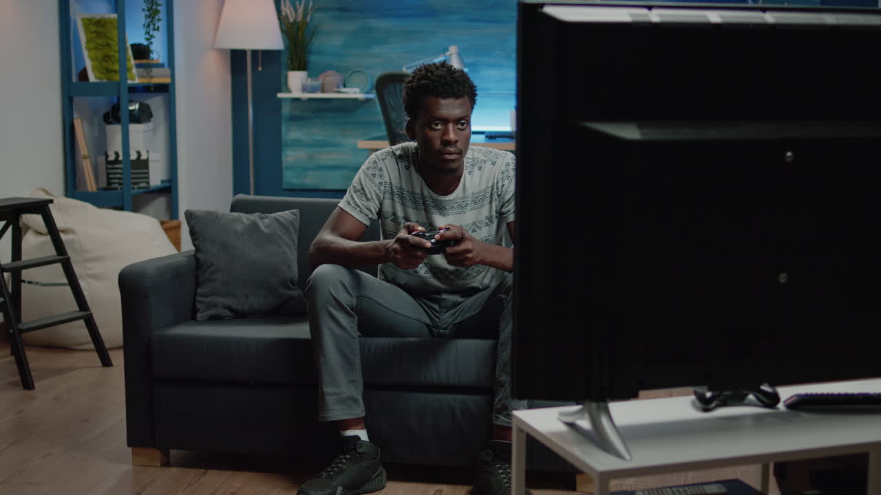 Person playing virtual video games and holding joystick