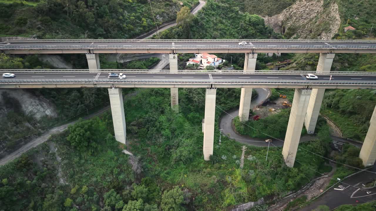 Aerial view of highway bridge in lush Taormina, Sicily, surrounded by greenery